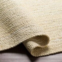 Cream Braided Jute Rug, Available In A Variety Of Sizes -Famous Furniture Store cream braided jute rug available in a variety of sizes rugs the well appointed house 6 f020af38 a56e 44a2 9195 2f0846a3e0af
